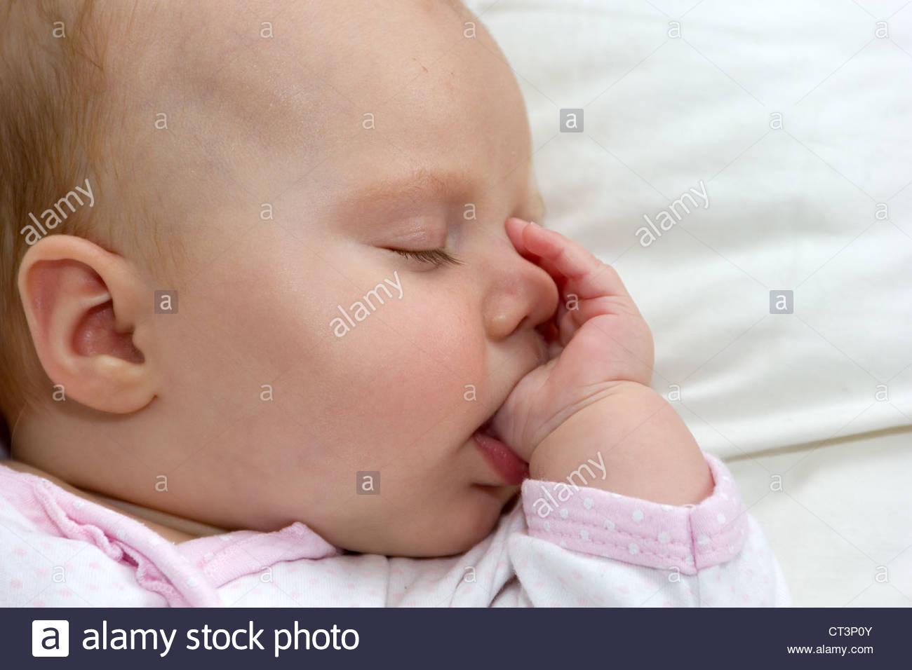 3-month-old-baby-asleep-on-a-pillow-sucking-her-thumb-CT3P0Y.jpg